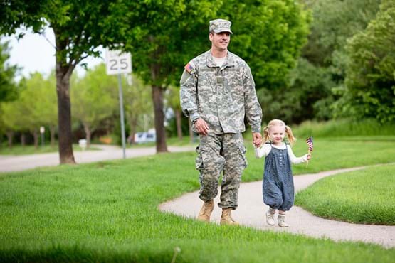 Veteran lelaki berjalan dengan anak perempuannya