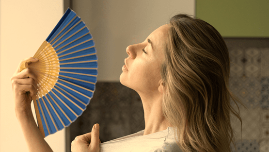 Woman fans herself on a hot day